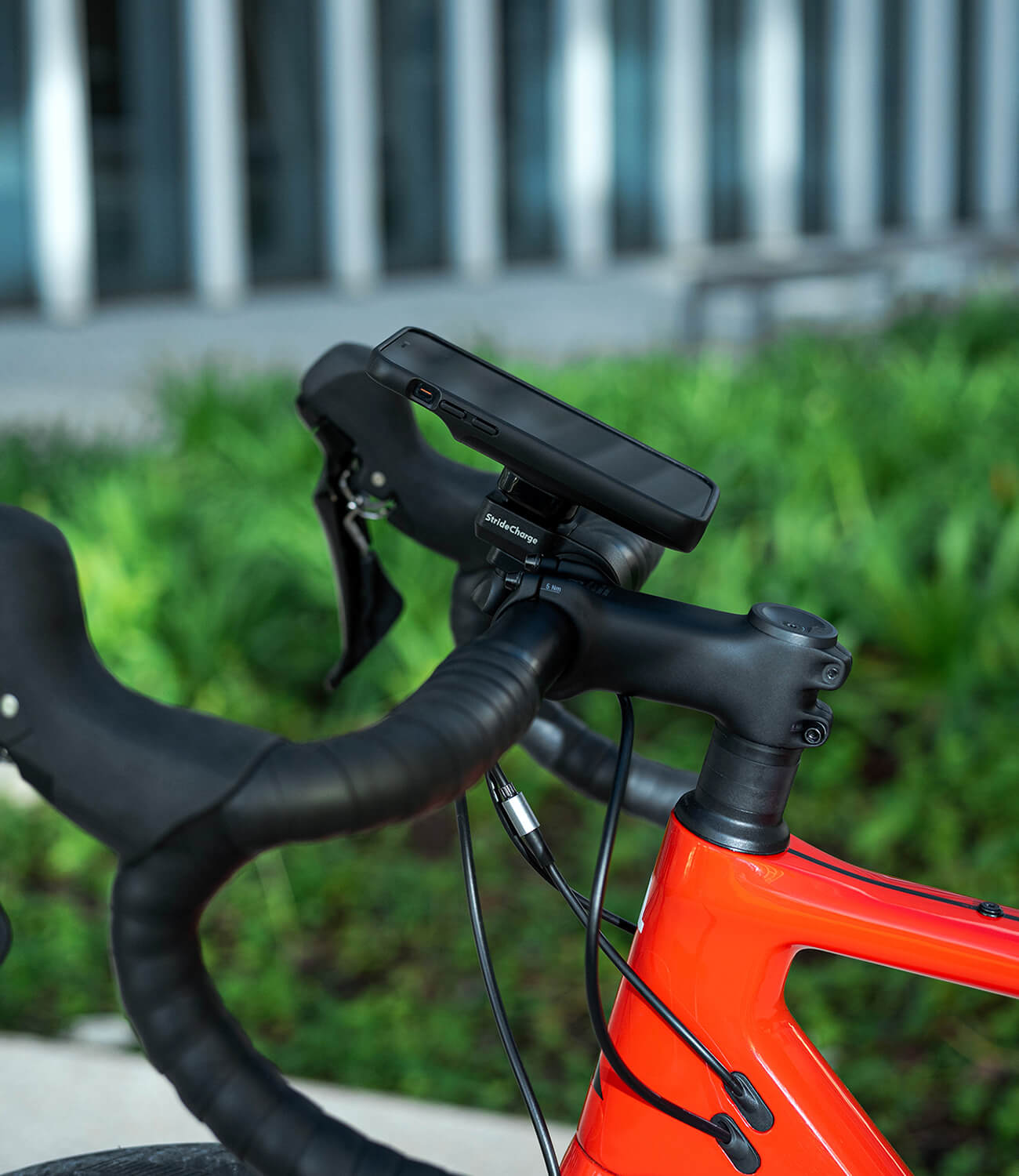 Side view of the StrideCharge Charge Case and Bike Mount attached to a bike's handlebars