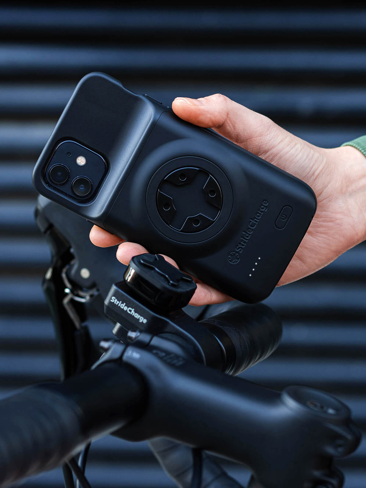 Close up of a person attaching the StrideCharge Charge Case to the Bike Mount