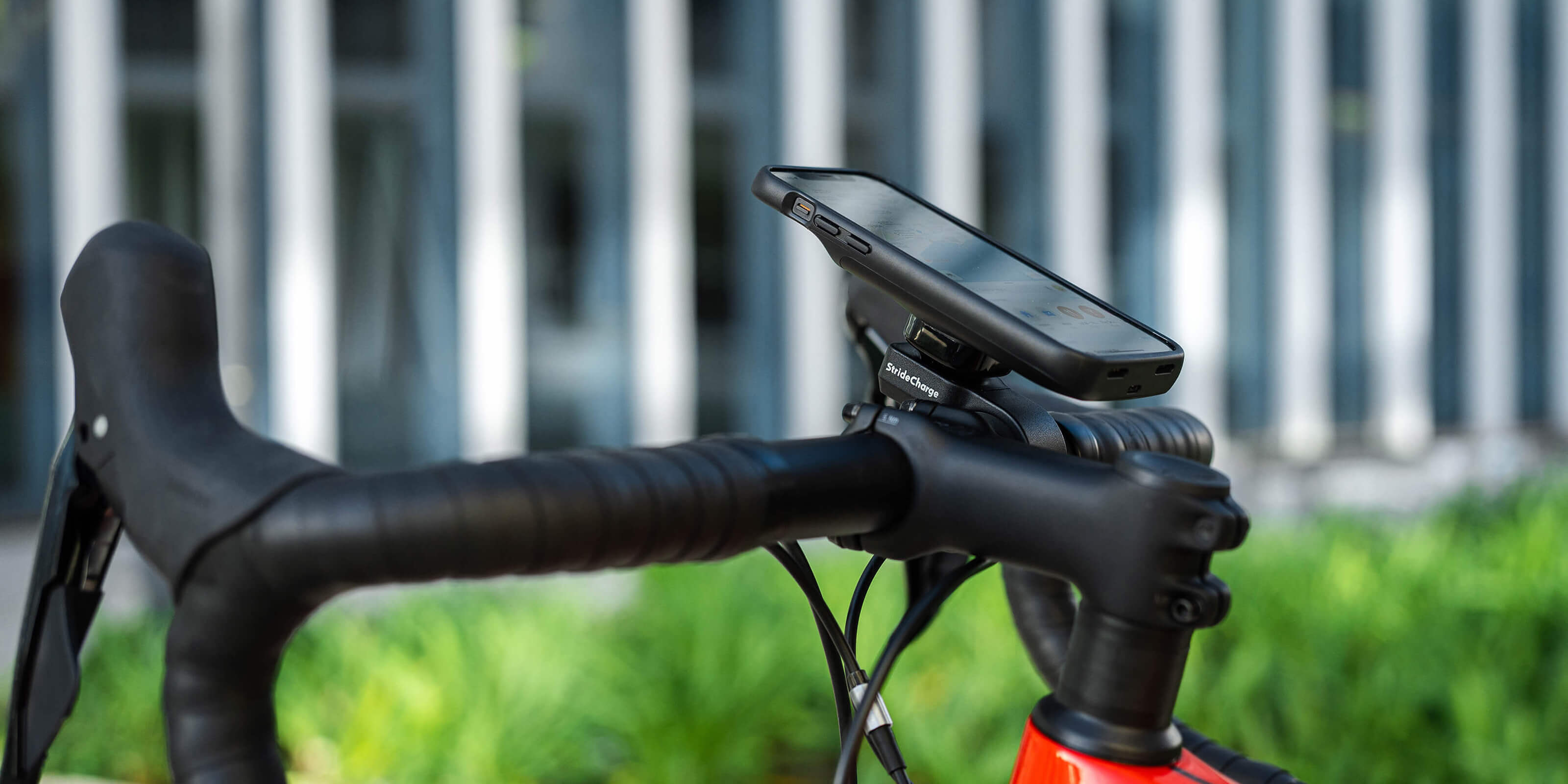 Side view of the StrideCharge Charge Case and Bike Mount attached to a bike's handlebars
